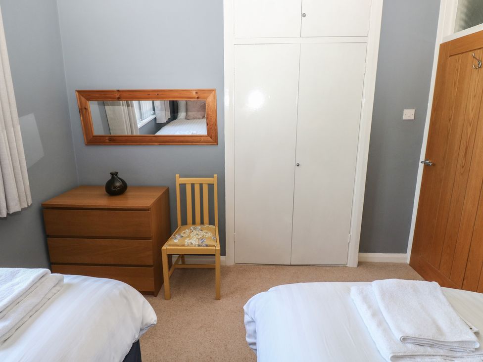 A bedroom with a bed and a dresser at Sea Haze in Tenby