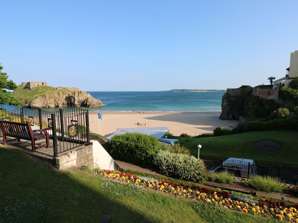 A beach view with ocean and flowers at Sea Haze in Tenby