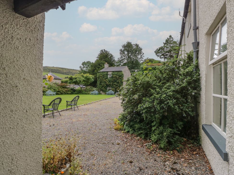 An outdoor area with chairs and bushes at The Old Kitchen in Cartmel