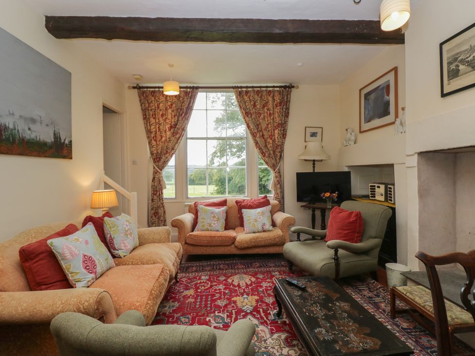 A living room with a sofa and armchair at The Old Kitchen Cartmel