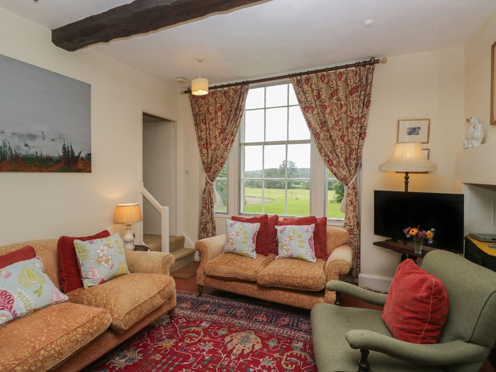 A living room with a sofa and armchair at The Old Kitchen in Cartmel