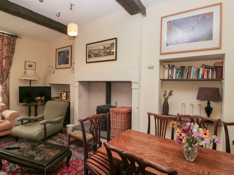 A living room with a sofa and a table at The Old Kitchen in Cartmel