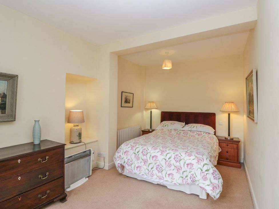 A bedroom with a bed and lamps at The Old Kitchen in Cartmel