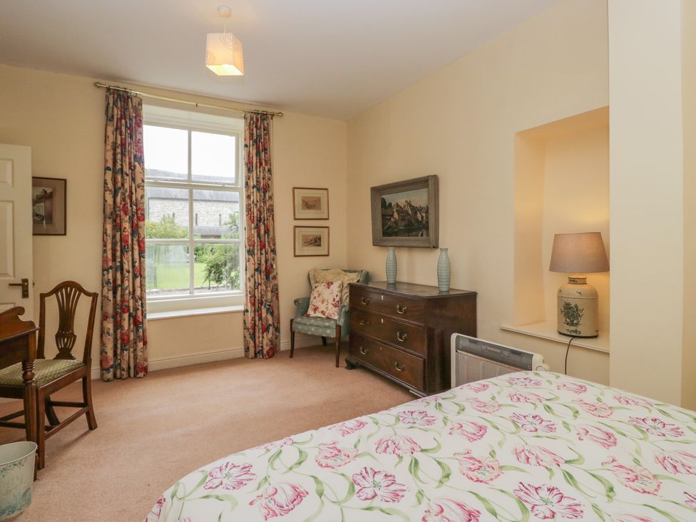 A bedroom with a bed and window at The Old Kitchen in Cartmel