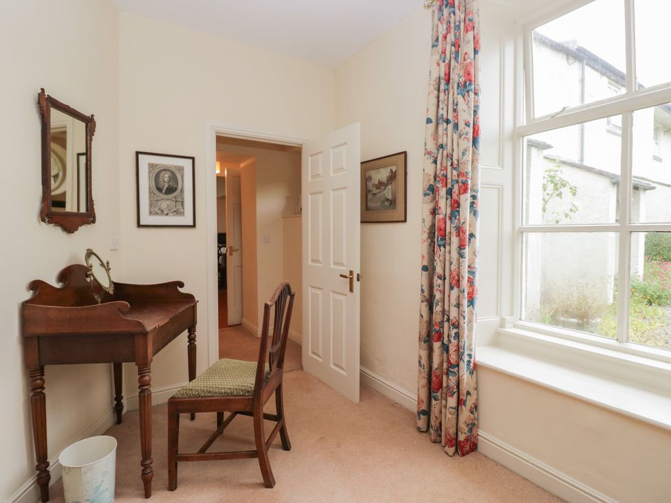 A room with a table and chair at The Old Kitchen in Cartmel