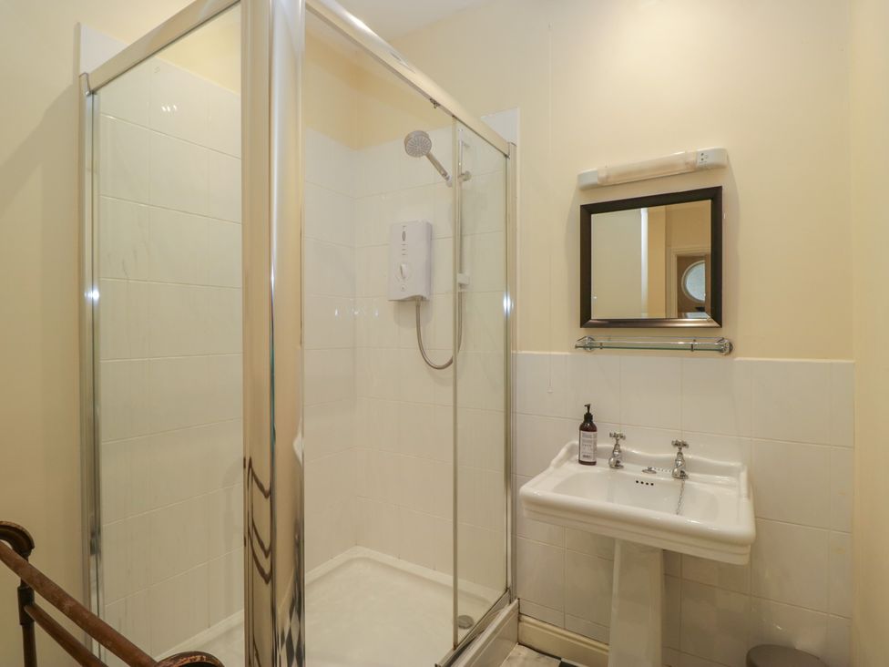 A bathroom with a shower enclosure and sink at The Old Kitchen in Cartmel