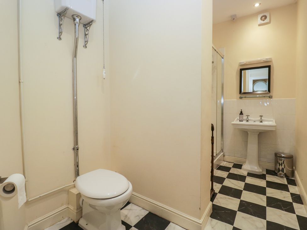 A bathroom with a toilet, sink, and shower at The Old Kitchen in Cartmel