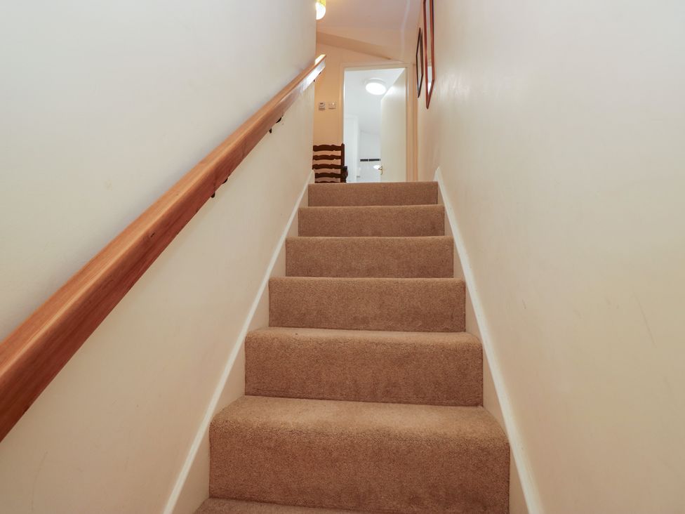 A staircase with carpet and a handrail at The Old Kitchen Cartmel