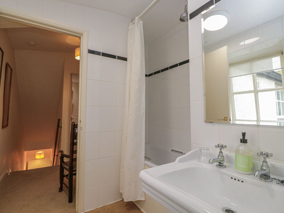 A bathroom with a bathtub and sink at The Old Kitchen in Cartmel