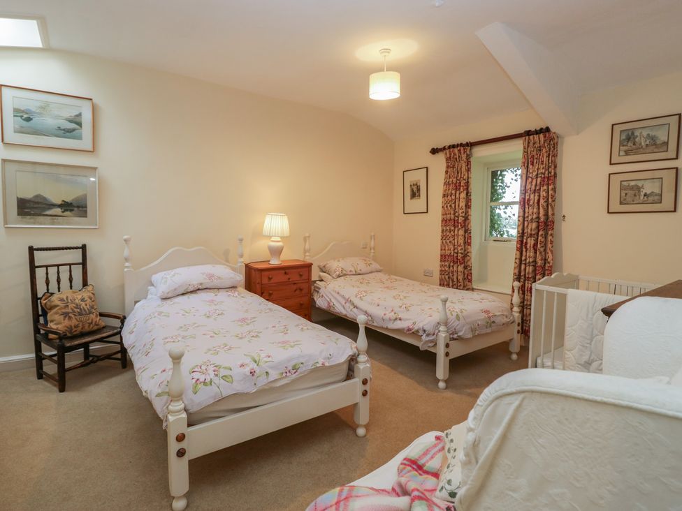 A bedroom with two beds and a chest of drawers at The Old Kitchen in Cartmel