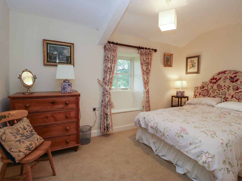 A bedroom with a bed and dresser at The Old Kitchen in Cartmel