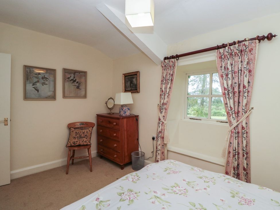 A bedroom with a bed and furniture at The Old Kitchen in Cartmel