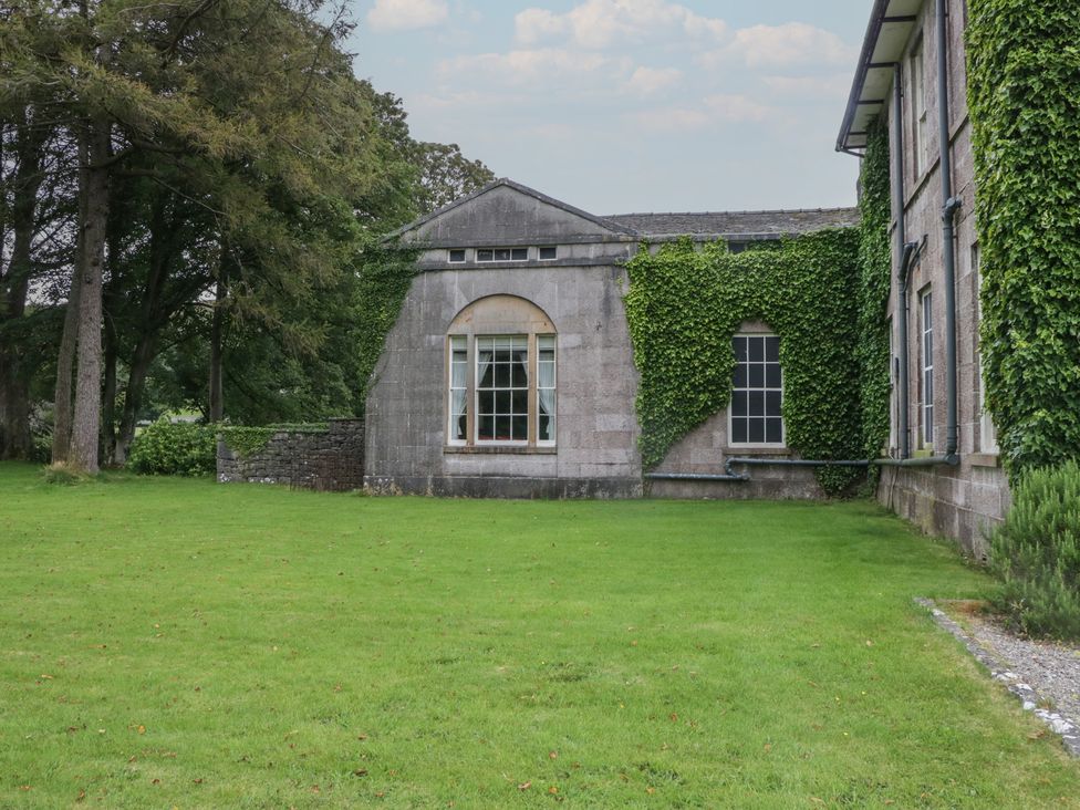 An outdoor area with a building covered in ivy at The Old Kitchen in Cartmel