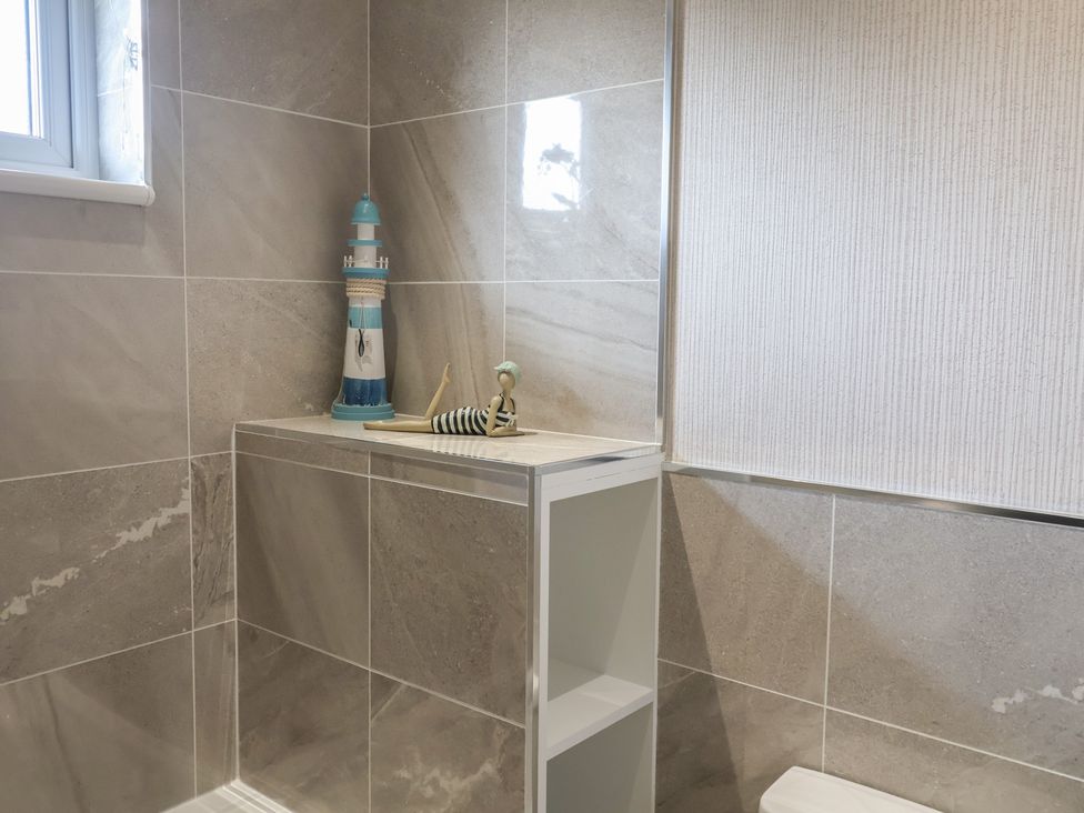 A bathroom featuring a toilet and decorative lighthouse at Lodge 1 Norwich