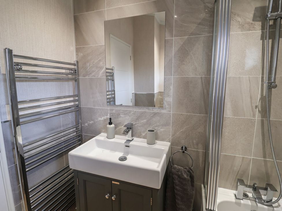 A bathroom with a sink and towel rail at Lodge 1 Norwich