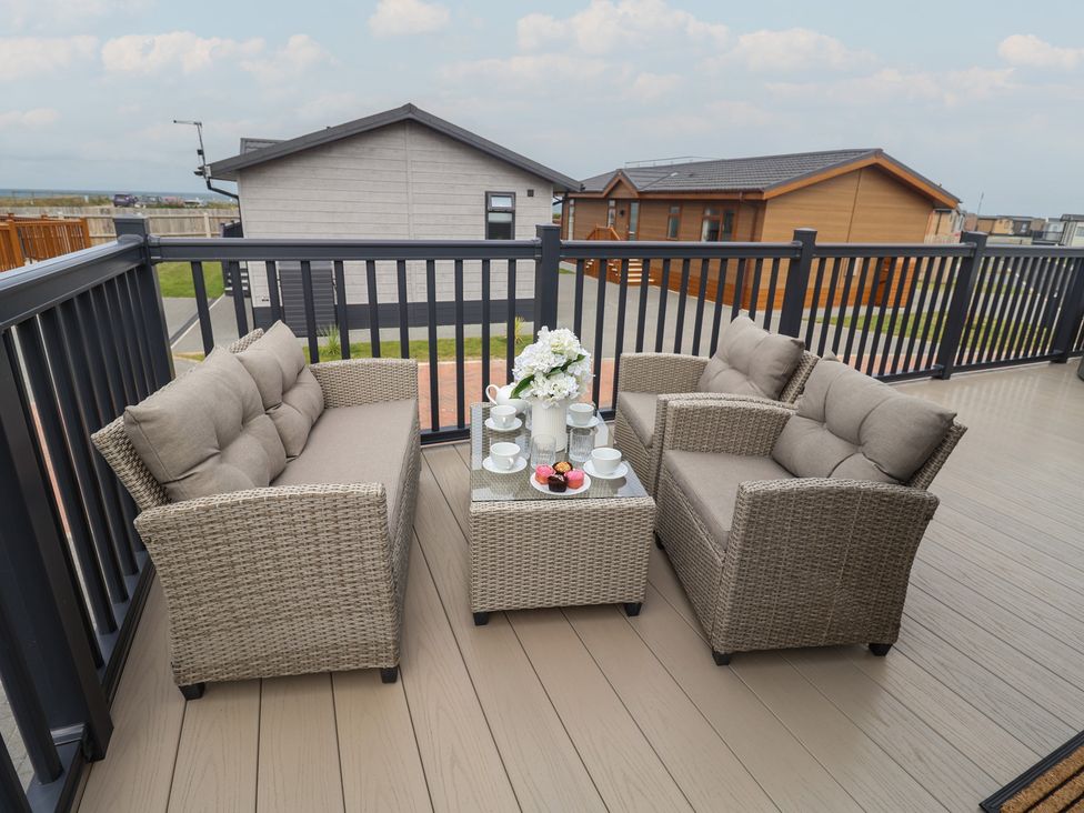 A patio with seating and a table at Lodge 1 in Norwich