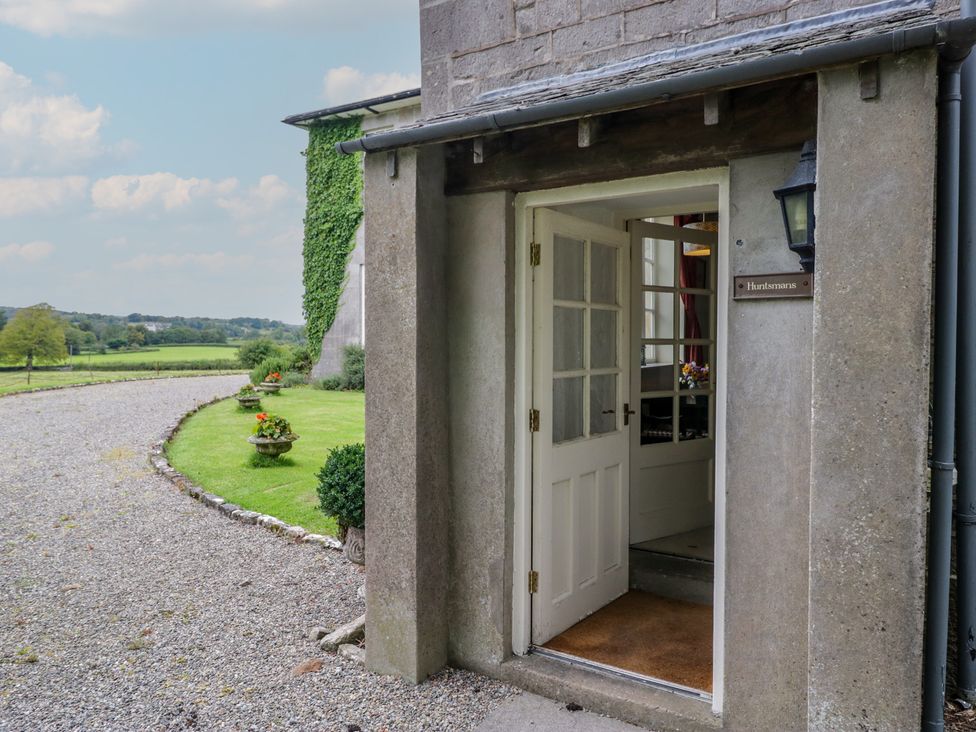An entrance with a door and steps at Huntsman's Cottage in Cartmel