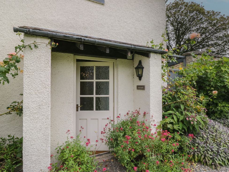 An entrance with a door and plants at The Laundrymaid's Cottage in Cartmel