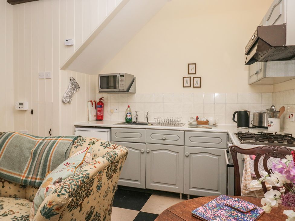A kitchen with a sink and appliances at The Laundrymaid's Cottage in Cartmel
