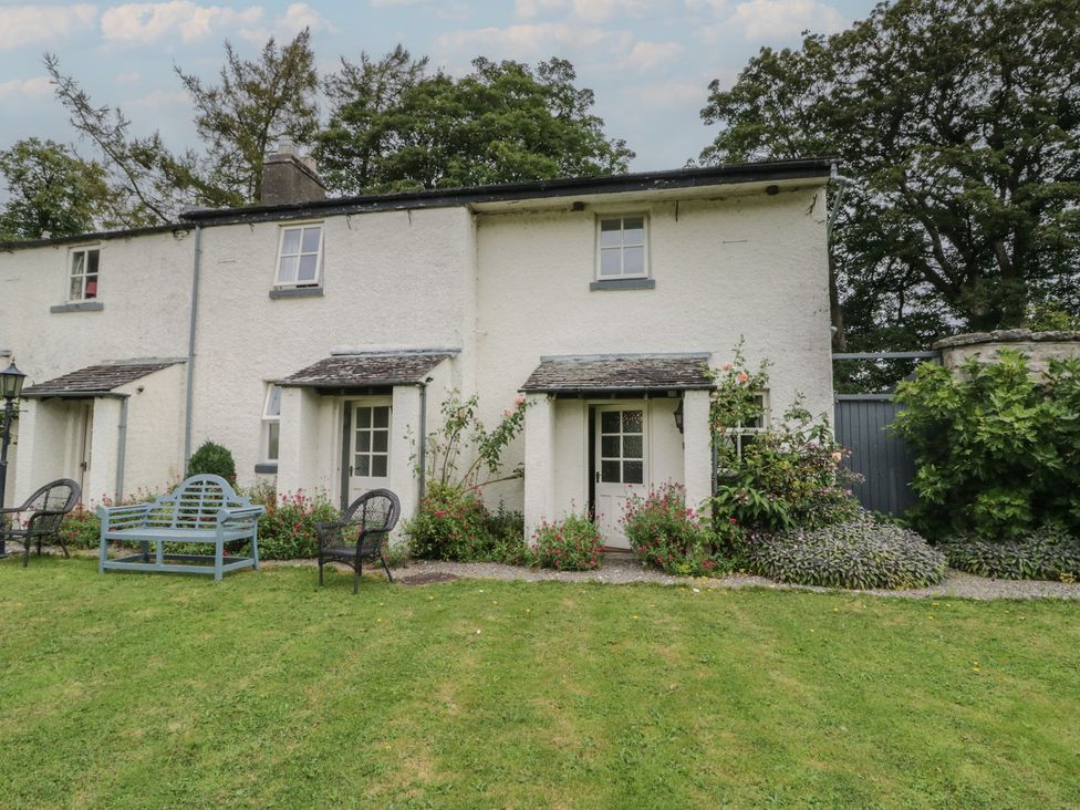 An outdoor view of a cottage with seating area at The Laundrymaid's Cottage in Cartmel