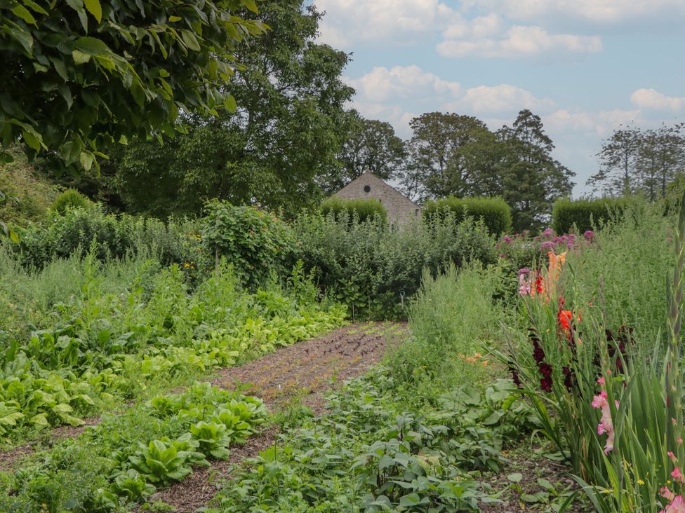 A garden with vegetables and flowers at The Laundrymaid's Cottage in Cartmel