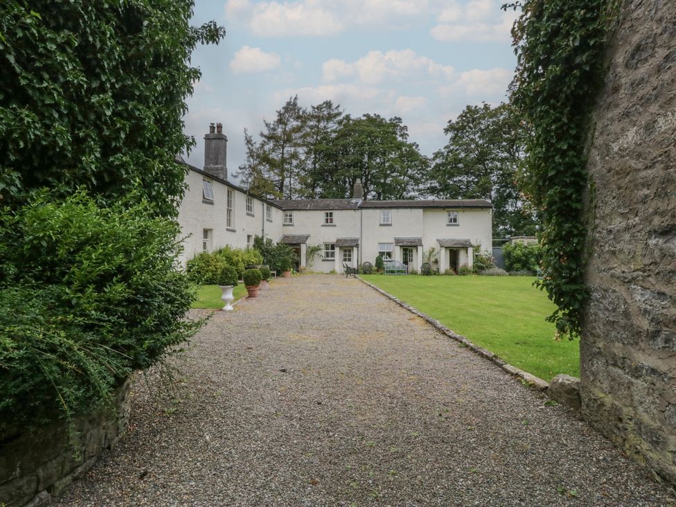 An outdoor area with a house and garden at The Laundrymaid's Cottage in Cartmel