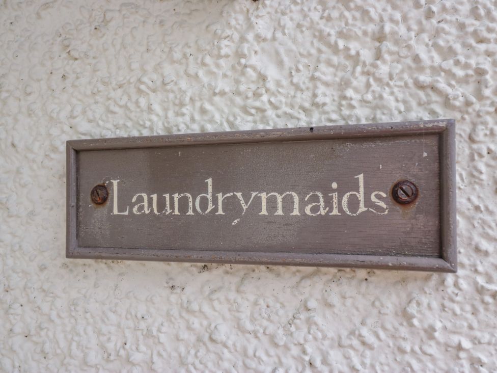 A sign that reads Laundrymaids at The Laundrymaid's Cottage in Cartmel