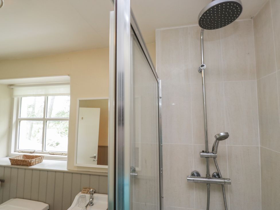 A bathroom with shower and bathtub at The Gameskeepers Cottage in Cartmel