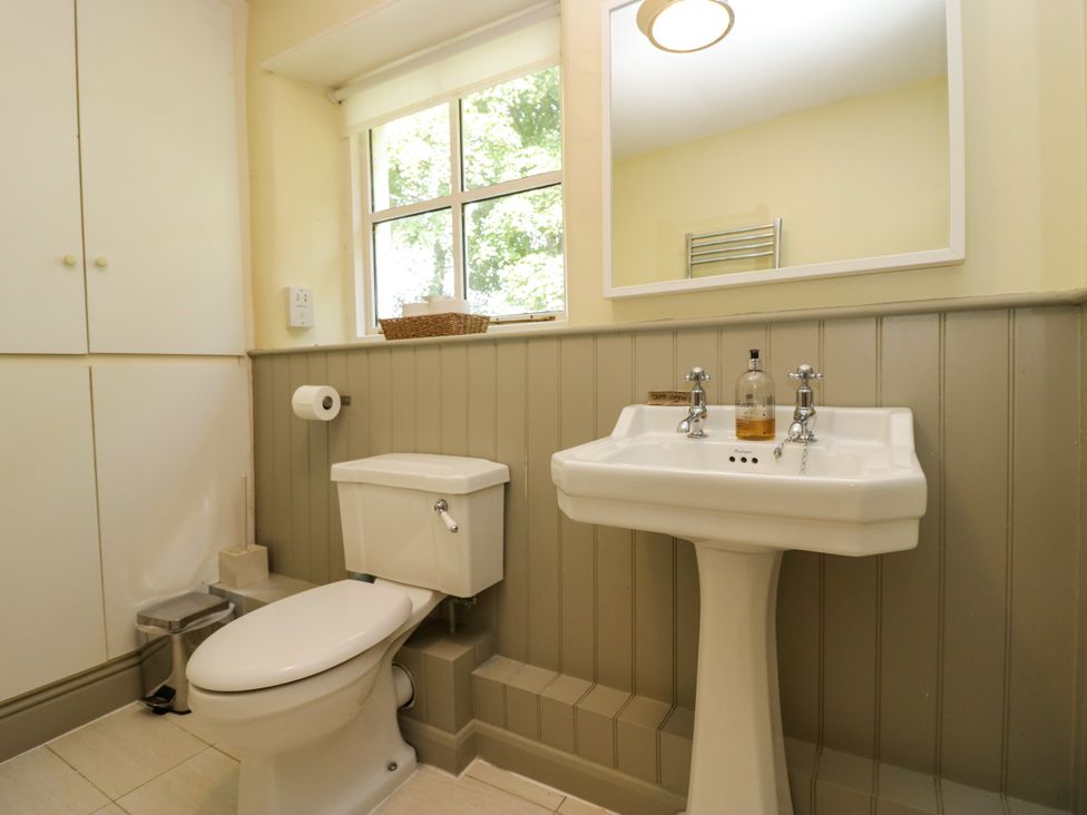 A bathroom with a toilet and sink at The Gameskeepers Cottage in Cartmel