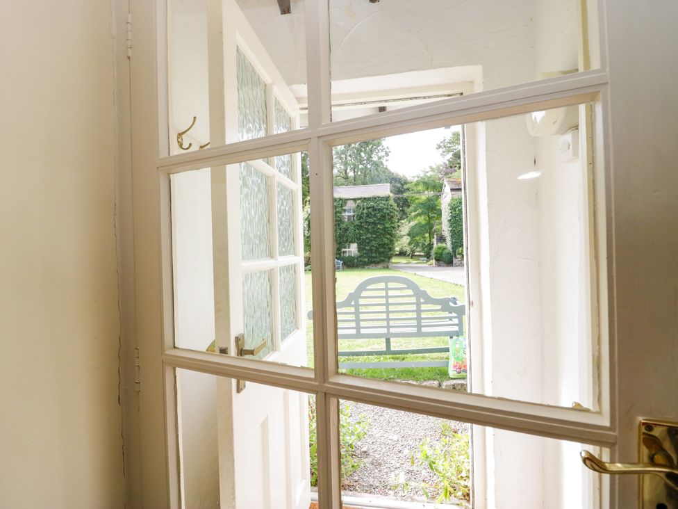An entrance view looking out to a garden area at The Gameskeepers Cottage in Cartmel