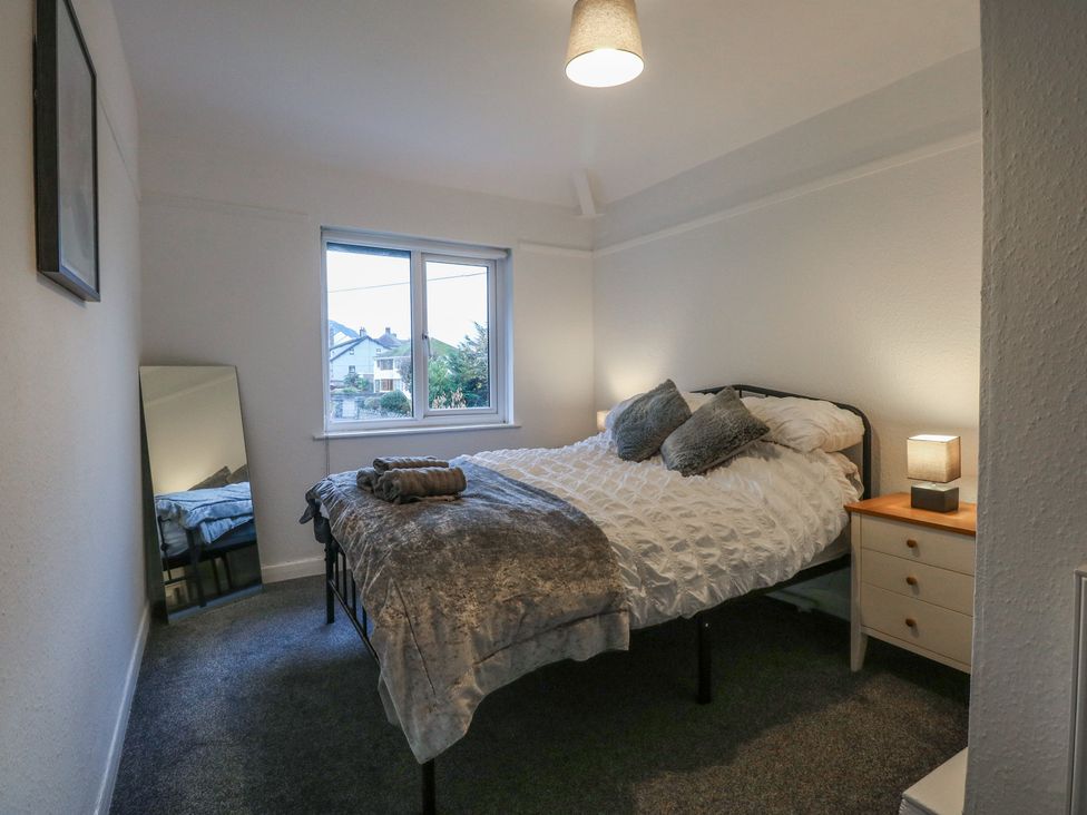 A bedroom with a bed and window at Tan Y Mynydd in Dwygyfylchi