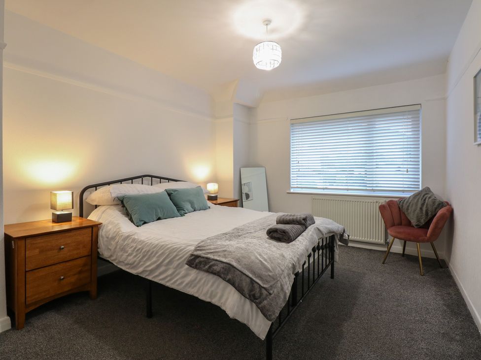 A bedroom with a bed and nightstands at Tan Y Mynydd in Dwygyfylchi