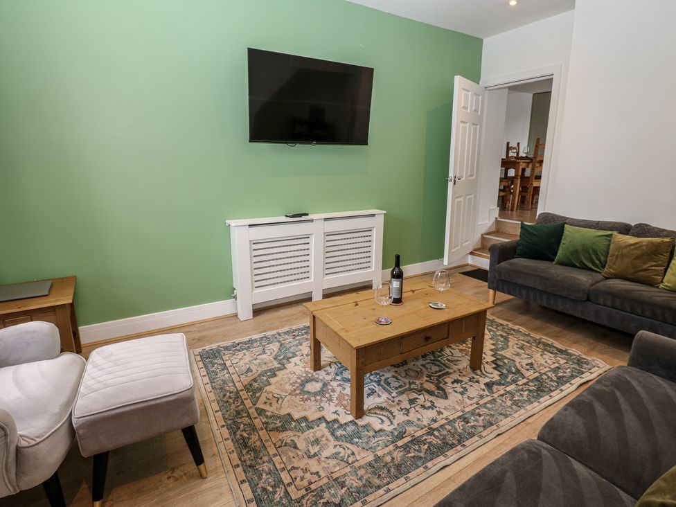 A living room with a coffee table and sofa at Salvin Cottage in Alston