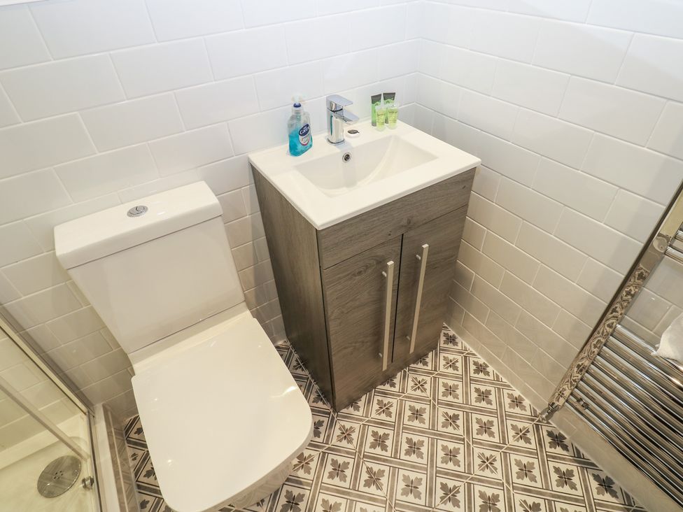 A bathroom with a toilet and sink at Salvin Cottage in Alston