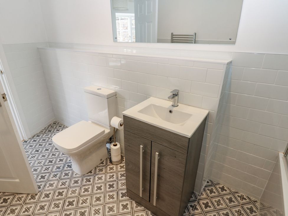 A bathroom with a sink and toilet at Salvin Cottage in Alston
