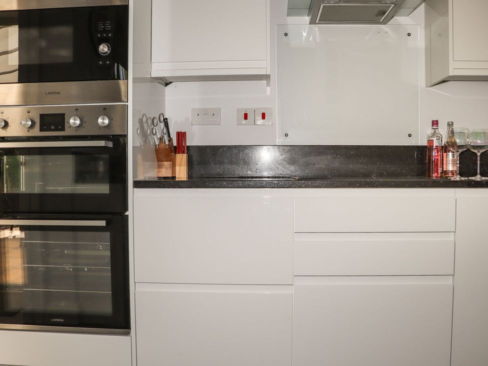 A kitchen with built-in appliances and countertop at Atlantic View (3 bed) in Bude