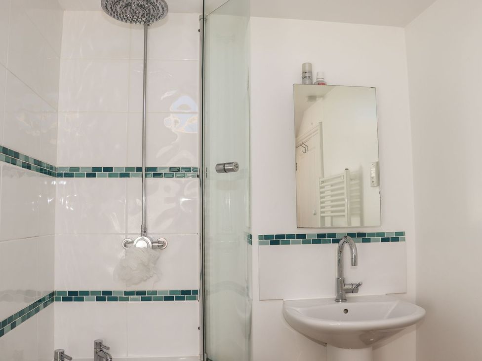 A bathroom with a shower and sink at Atlantic View (3 bed) in Bude