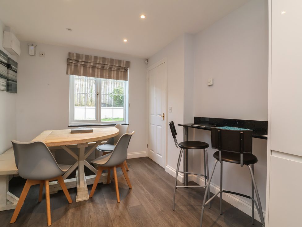 A kitchen with a dining table and chairs at Atlantic View in Poundstock near Bude