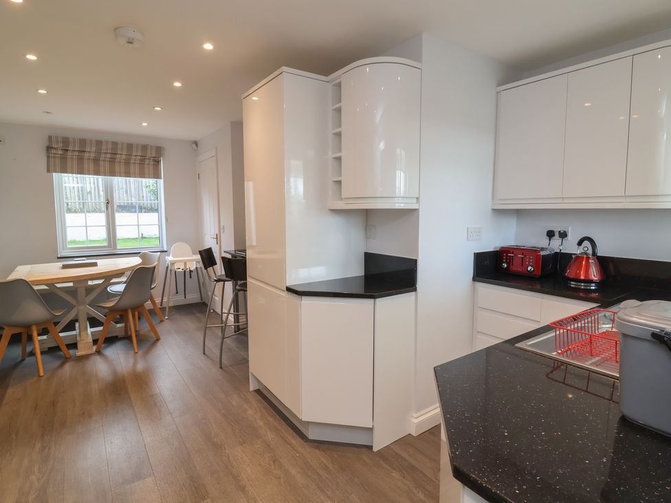 A kitchen with a table and chairs at Atlantic View Poundstock near Bude