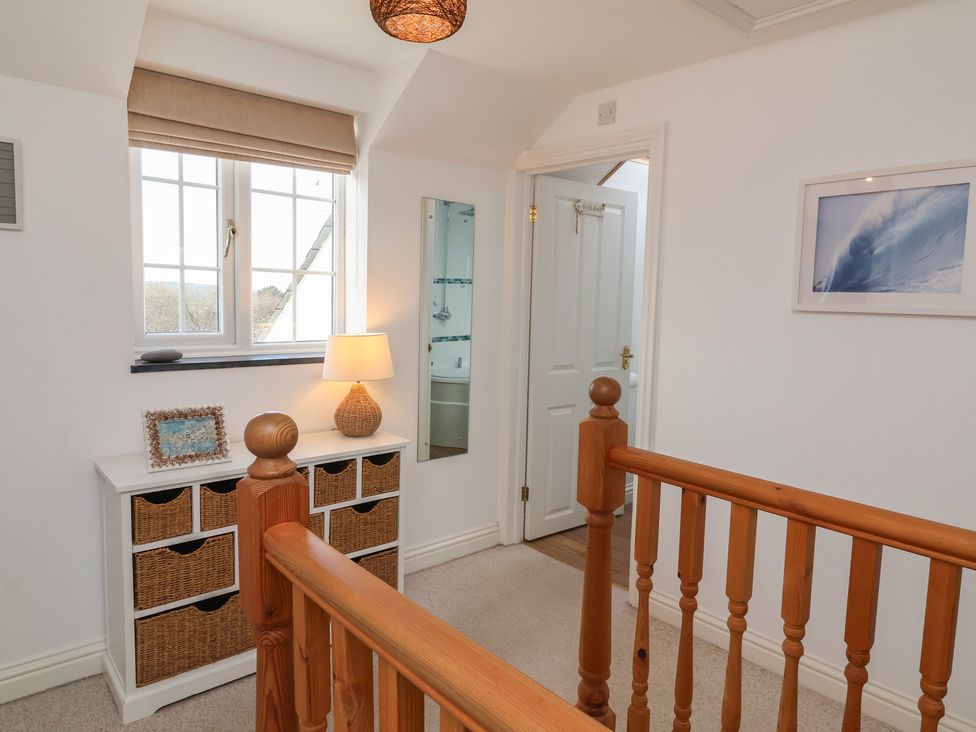 A hallway with a drawer unit and a table lamp at Atlantic View Poundstock near Bude