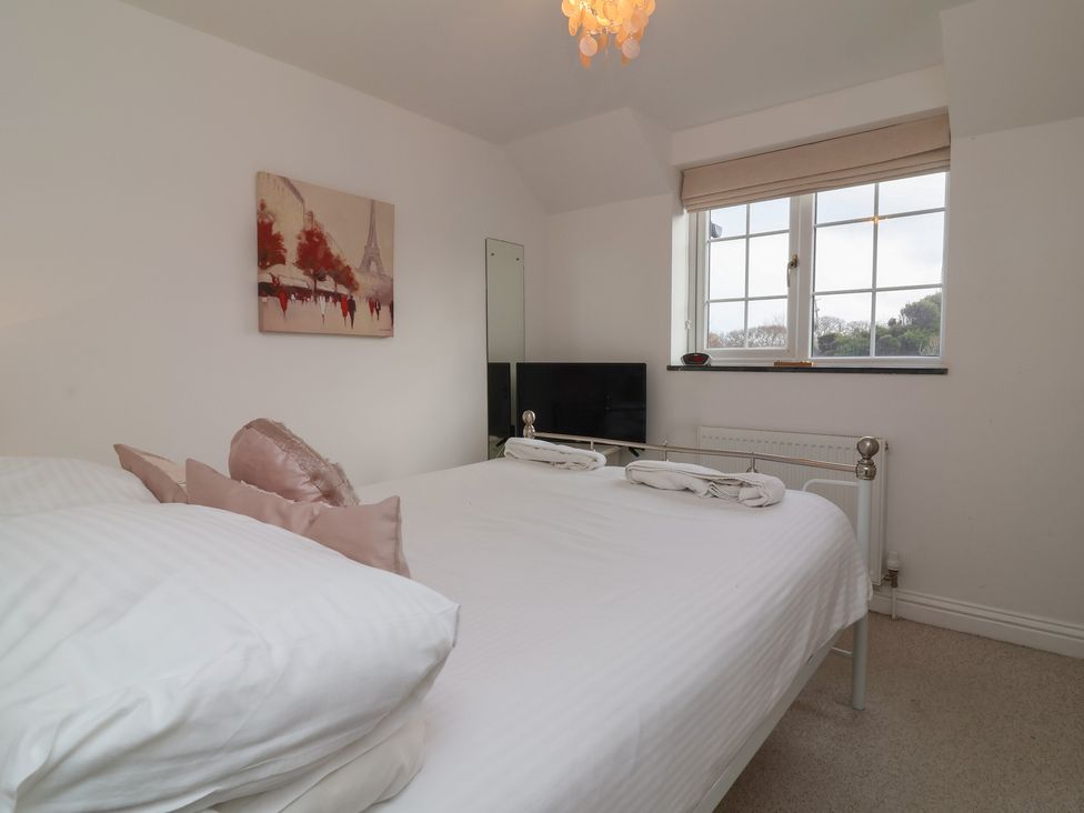 A bedroom with a bed and television at Atlantic View in Poundstock near Bude