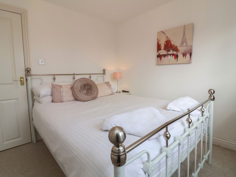 A bedroom with a metal bed and a lamp at Atlantic View in Poundstock near Bude
