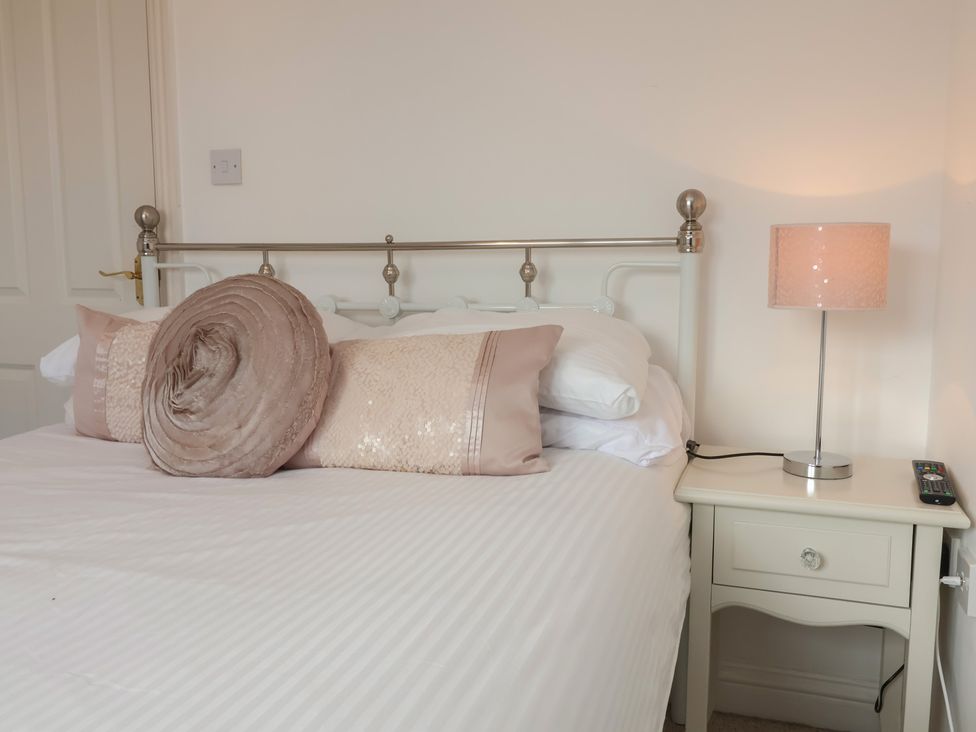 A bedroom with a bed and lamp at Atlantic View in Poundstock near Bude