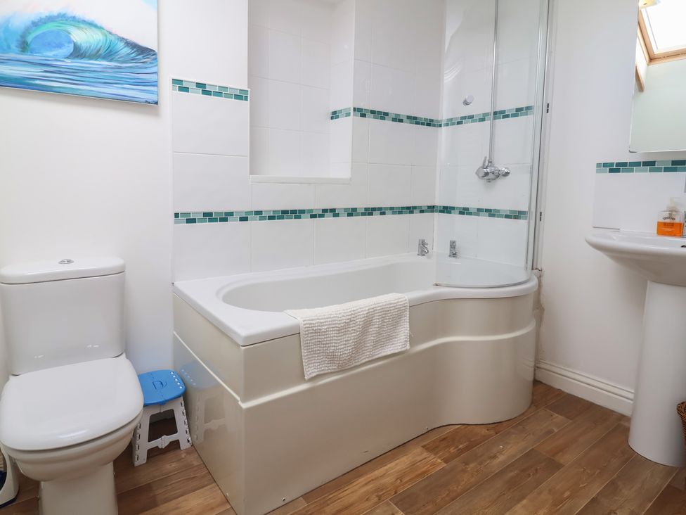 A bathroom with a bath tub and a toilet at Atlantic View in Poundstock near Bude