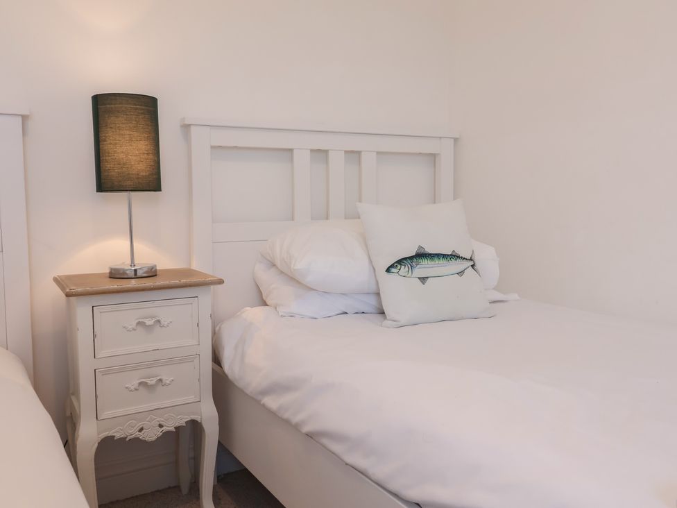 A bedroom with a bed and a lamp at Atlantic View in Poundstock near Bude