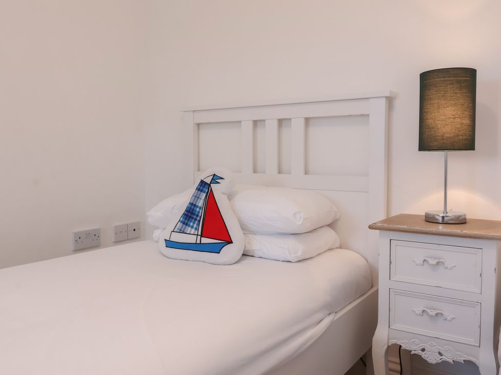 A bedroom with a bed and lamp at Atlantic View Poundstock near Bude