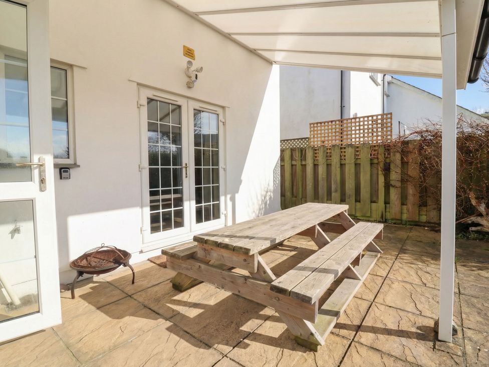 A patio area with a picnic table and grill at Atlantic View Poundstock near Bude