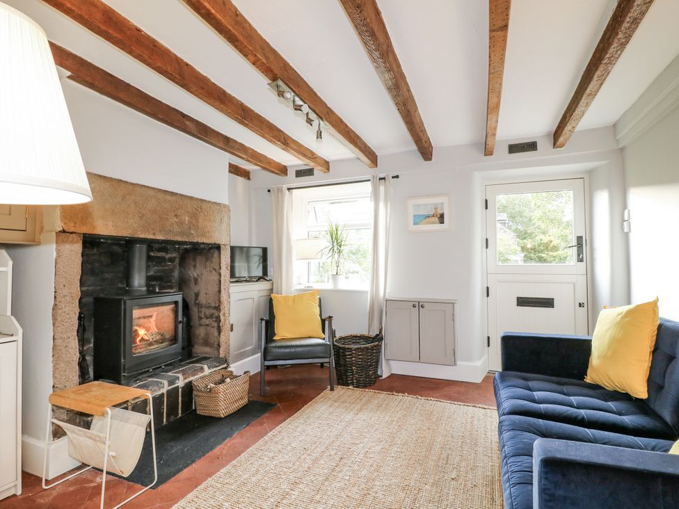 A living room with a fireplace and sofa at 5 Belper Lane End in Belper
