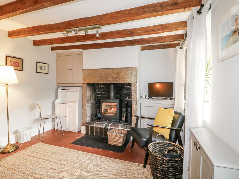 A living room with a fireplace and television at 5 Belper Lane End Belper