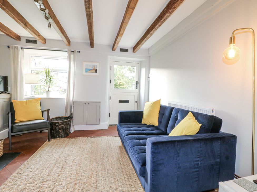 A living room with a sofa and armchair at 5 Belper Lane End in Belper